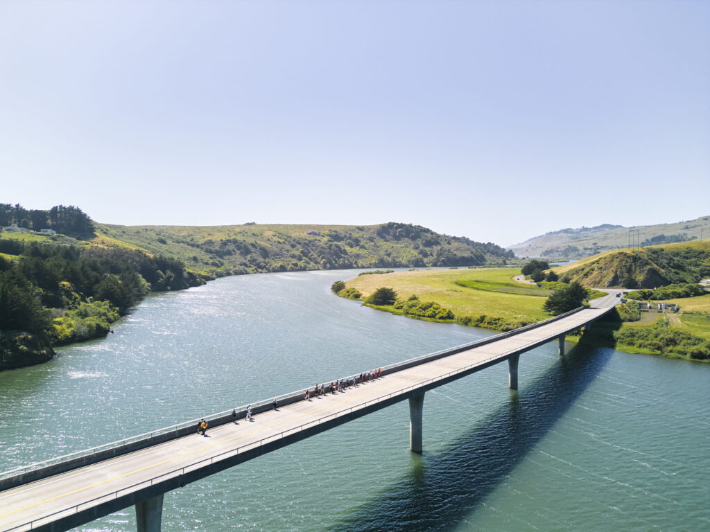 Hikers cross the Bridgehaven bridge at Highway 1 in Jenner as they hike Stage 5 of the Camino de Sonoma. (Kim Carroll)