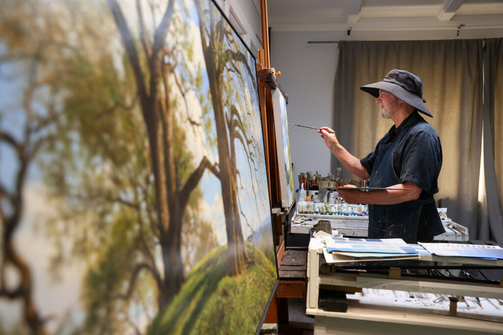 Christopher Leith Evans works on a painting in his home studio in Healdsburg on Monday, May 11, 2026. (Christopher Chung/The Press Democrat)