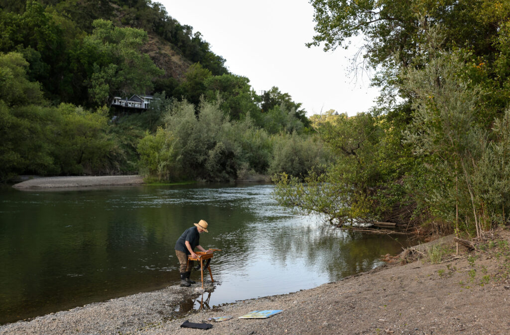 Christopher Leith Evans packs up his French easel after painting along the Russian River near his home in Healdsburg on Monday, May 11, 2026. (Christopher Chung/The Press Democrat)