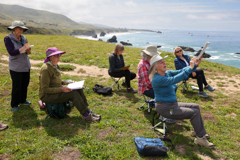 California Naturalist Sarah Reid, right, describes how to illustrate the coastal landscape and rock features while leading a Nature Journaling class on the bluffs above Shell Beach, north of Bodega Bay on Monday, May 4, 2026. (Christopher Chung/The Press Democrat)