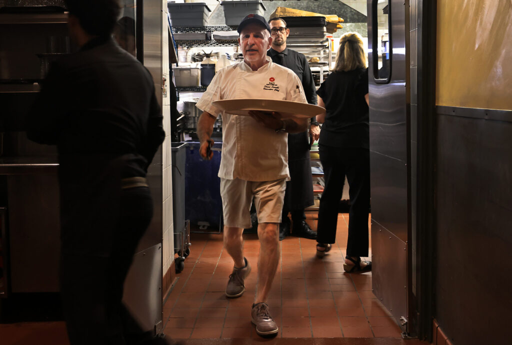 Baci Cafe and Wine Bar chef Shari Sarabi and husband to Lisbeth Holmefjord, serves up hors d'oeuvres during reopening of the restaurant, Wednesday, July 29, 2026, after a vehicle slammed through the front of the Healdsburg establishment in May. (Kent Porter / The Press Democrat)