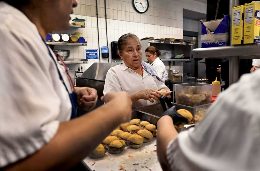 The kitchen staff at Baci Cafe and Wine Bar plate appetizers during reopening of the restaurant, Wednesday, July 29, 2026, after a vehicle slammed through the front of the Healdsburg establishment in May. (Kent Porter / The Press Democrat)