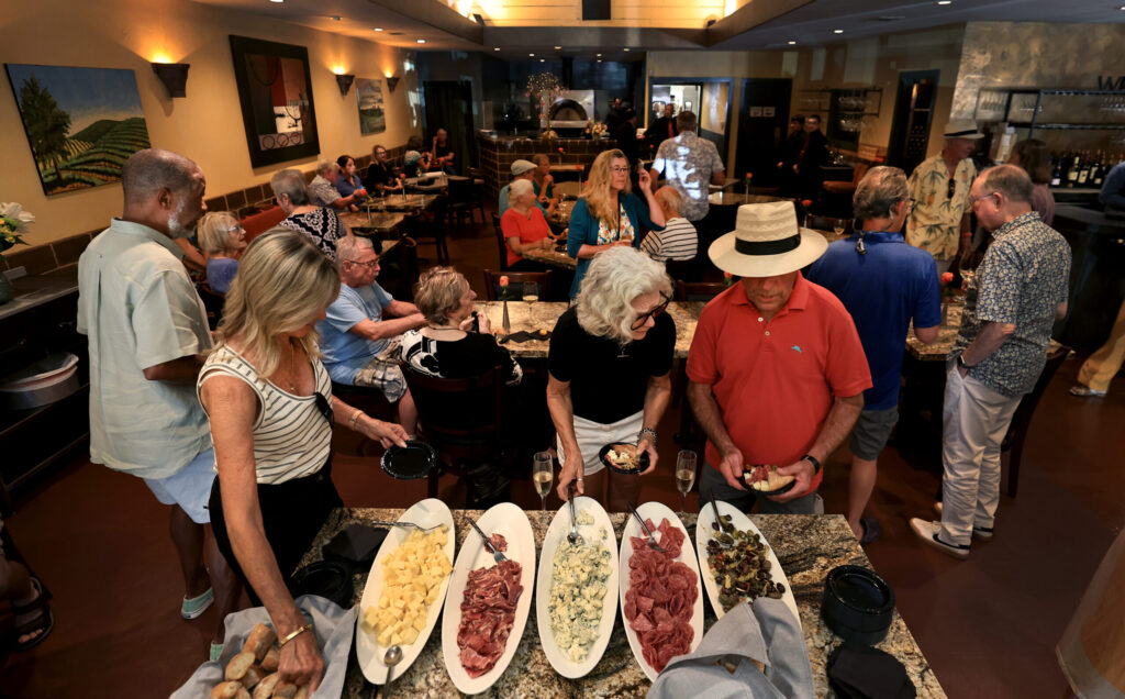 Guests crowd Baci Cafe and Wine Bar at the reopening of the restaurant, Wednesday, July 29, 2026, after a vehicle slammed through the front of the Healdsburg establishment in May. (Kent Porter / The Press Democrat)