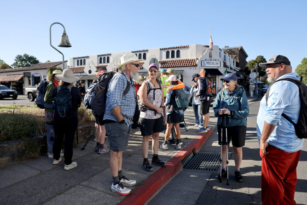 Pilgrims gather at Sonoma Plaza before heading out on Stage 1 of the Camino de Sonoma. Photo taken in Sonoma on Thursday, May 14, 2026. (Beth Schlanker / The Press Democrat)