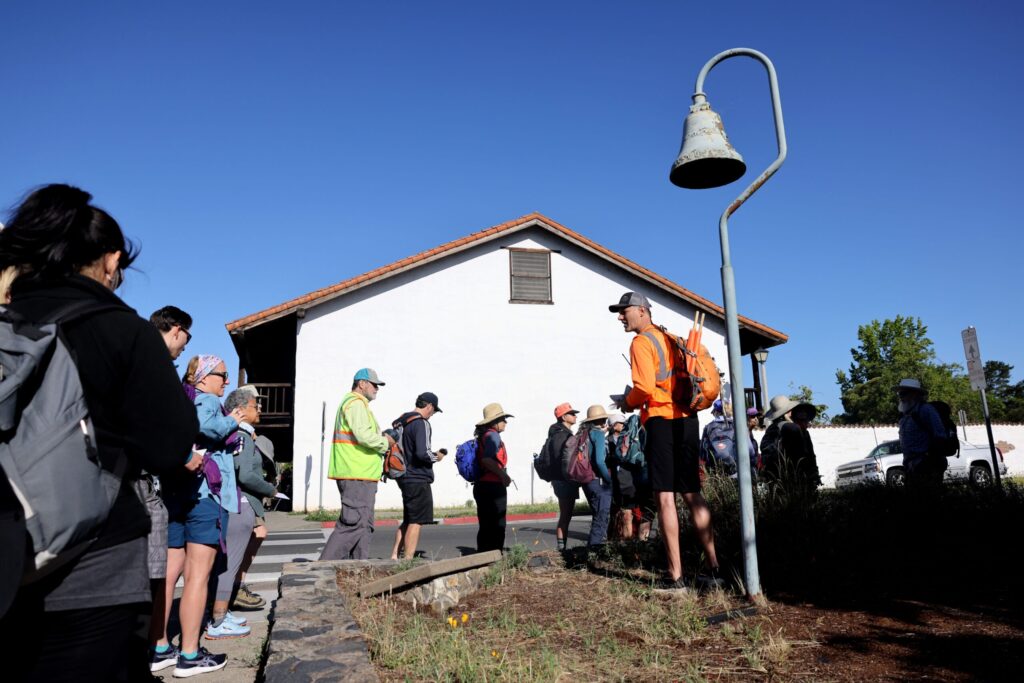 Pilgrims gather at Sonoma Plaza before heading out on Stage 1 of the Camino de Sonoma. Photo taken in Sonoma on Thursday, May 14, 2026. (Beth Schlanker / The Press Democrat)