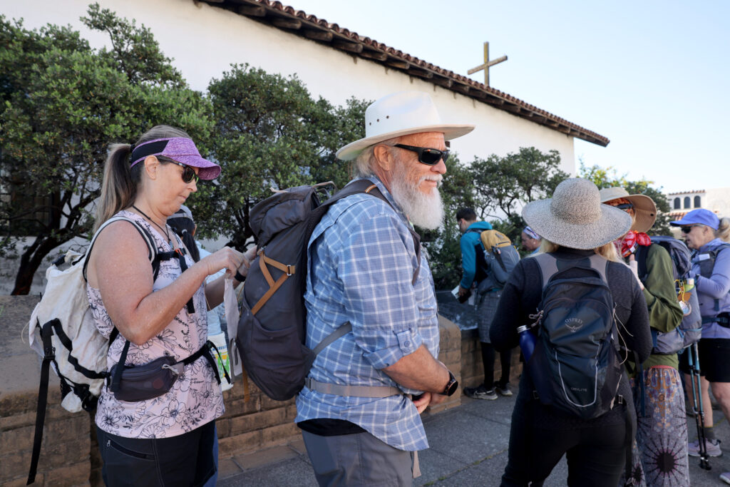 Pilgrims gather at Sonoma Plaza before heading out on Stage 1 of the Camino de Sonoma. Photo taken in Sonoma on Thursday, May 14, 2026. (Beth Schlanker / The Press Democrat)