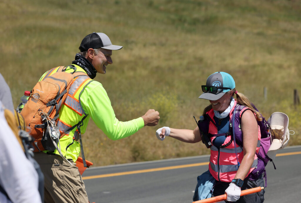 Tony "Camino" McCormick gives encouragement to a hiker on the Camino de Sonoma in Fort Ross Tuesday, May 19, 2026. (Beth Schlanker / The Press Democrat)