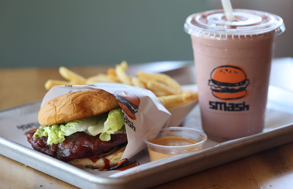 The “Nashville” Hot Fried Chicken Sando with fries and a Chocolate Therapy milkshake at SMASH in Sonoma Thursday, July 16, 2026. (Beth Schlanker / The Press Democrat)