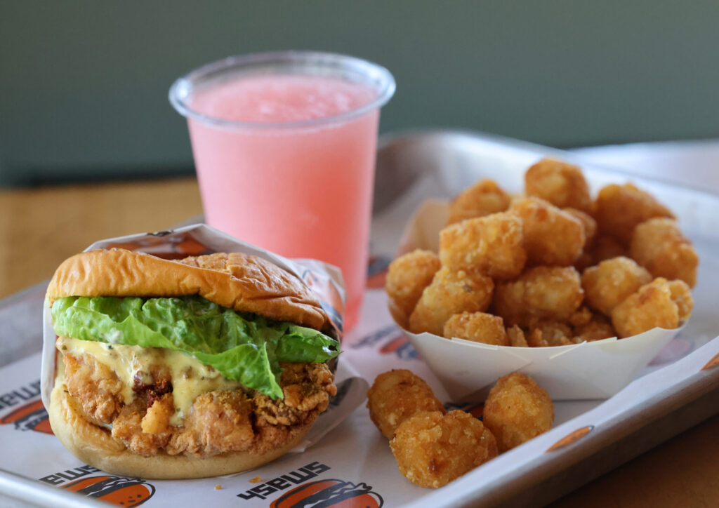 Smash Fried Chicken Sando, tater tots fries, and a frozen Rosé slush at SMASH in Sonoma Thursday, July 16, 2026. (Beth Schlanker / The Press Democrat)