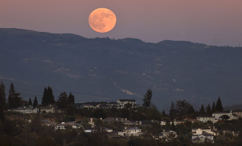 The July full ‘Buck Moon” rises over the Mayacamas Mountains and Fountaingrove, Tuesday, July 28, 2026, in Santa Rosa. (Kent Porter / The Press Democrat)