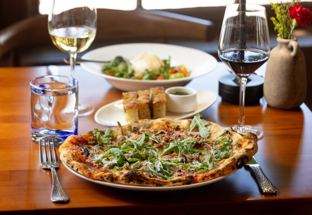 Funghi and Salsicce Pizza with wild mushrooms, Italian sausage, fontina and arugula from Capriciano Osteria Thursday, July 30, 2026 in Santa Rosa. (John Burgess/The Press Democrat)