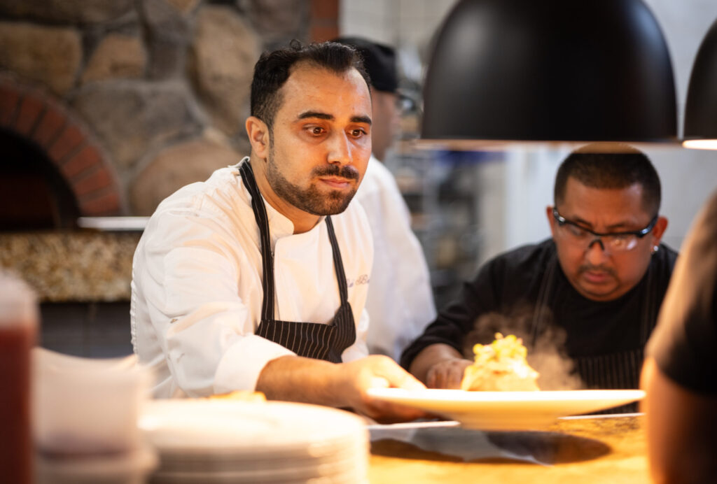 Owner/chef Baki Bekci finishes plates in the kitchen at Capriciano Osteria Thursday, July 30, 2026 in Santa Rosa. (John Burgess/The Press Democrat)