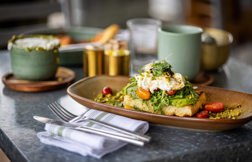 Avocado toast with a pistachio latté, left, from the Dolce Rosa Café Thursday, August 20, 2026 in Santa Rosa. (John Burgess/The Press Democrat)