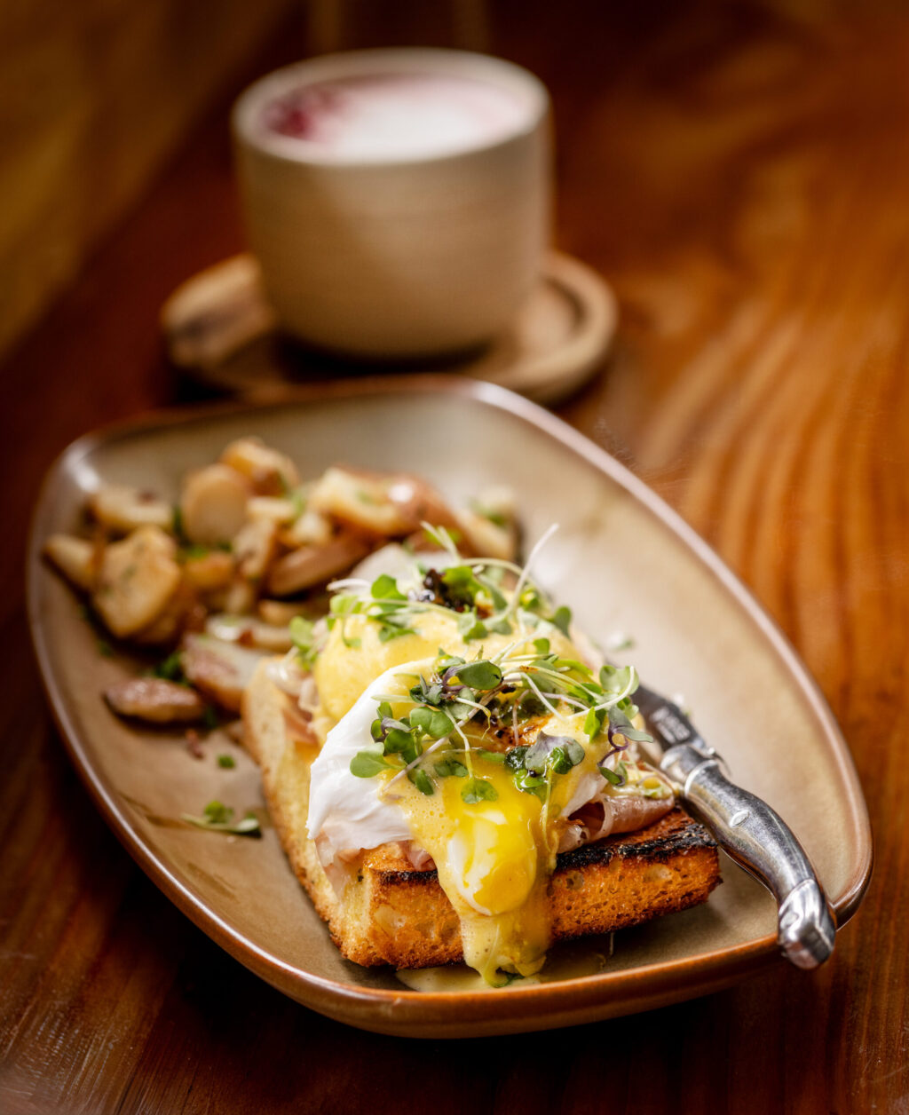 Pesto, prosciutto, and roasted tomato Benedict with hollandaise sauce and killer chili crunch from the Dolce Rosa Café Thursday, August 20, 2026 in Santa Rosa. (John Burgess/The Press Democrat)