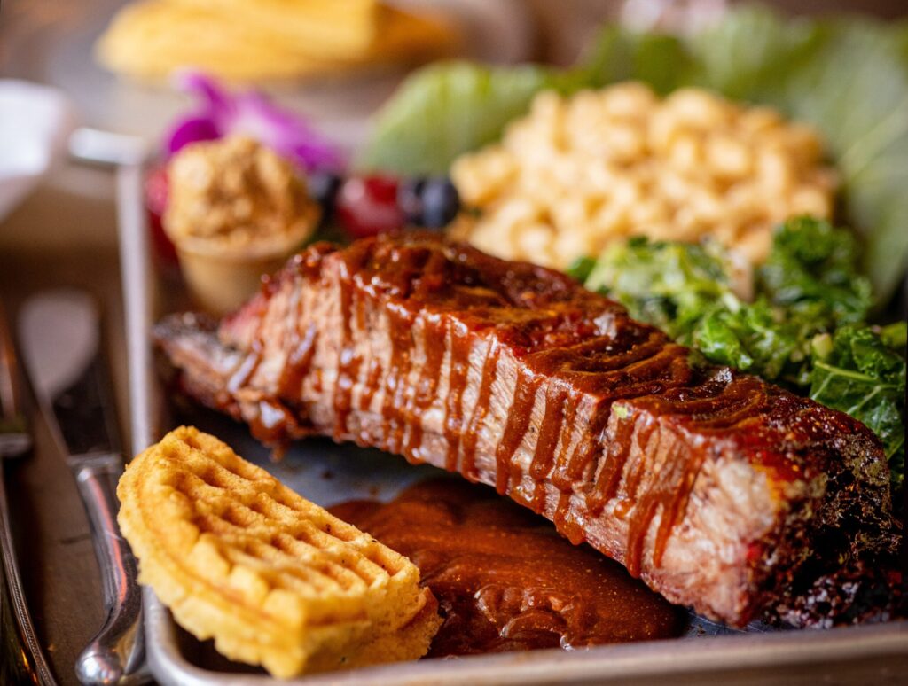 Beef Ribs with mac & cheese and cornbread waffles with crack butter from Spicy Mama’s Book Joint Friday, July 18, 2026 in Guerneville. (John Burgess/The Press Democrat)
