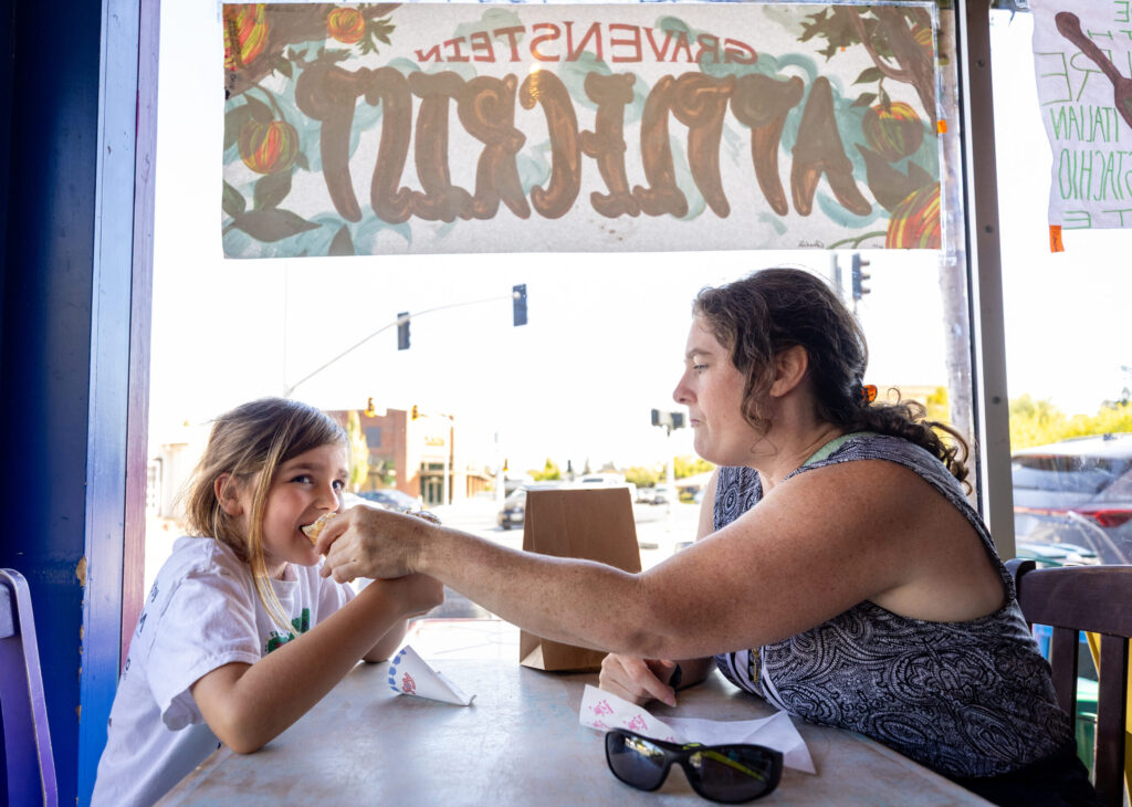 Jessie Lemer of Camp Meeker lets her son Owen, 8 try her flavor of ice cream at Screamin’ Mimi’s Tuesday, Aug. 11, 2026 in Sebastopol. (John Burgess/The Press Democrat)
