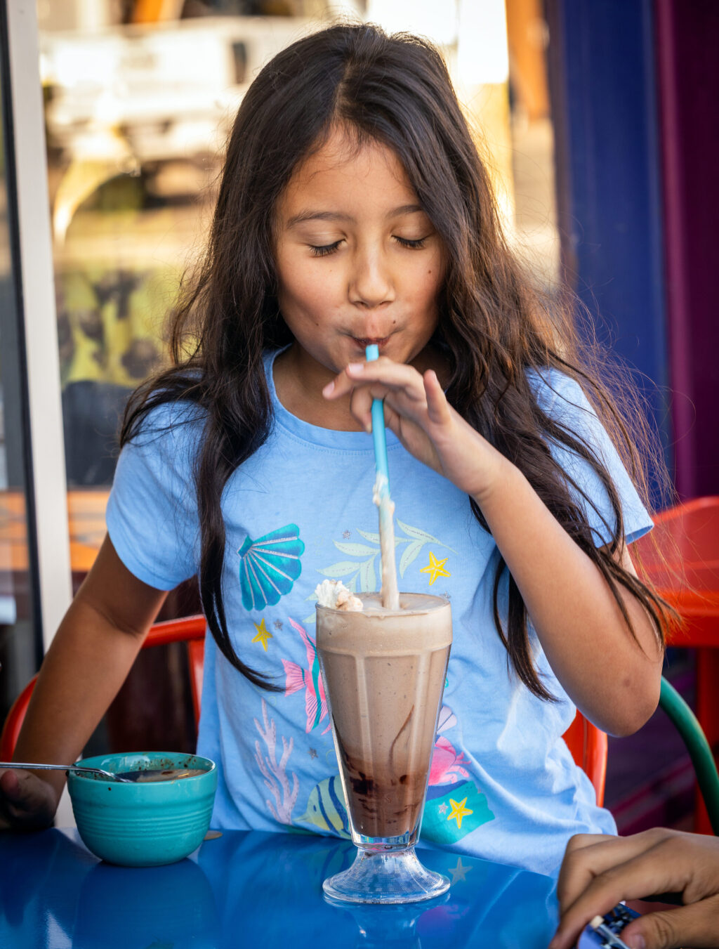 Athena Young 8, relishes a chocolate shake at Screamin’ Mimi’s Tuesday, Aug. 11, 2026 in Sebastopol. (John Burgess/The Press Democrat)