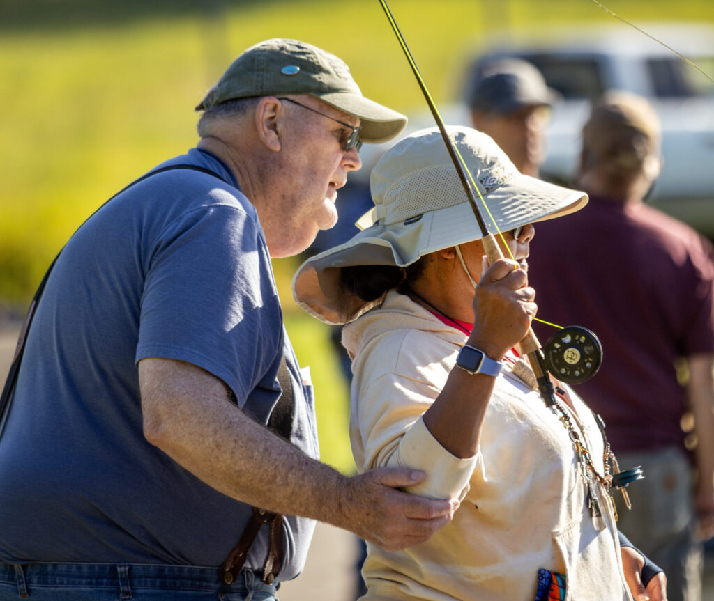 Russian River Fly Fishers member Paul Matzen, left, teaches Kim Austin the basic casting motion Thursday, May 7, 2026 at the casting pond in Santa Rosa’s Galvan Park. (John Burgess/The Press Democrat)