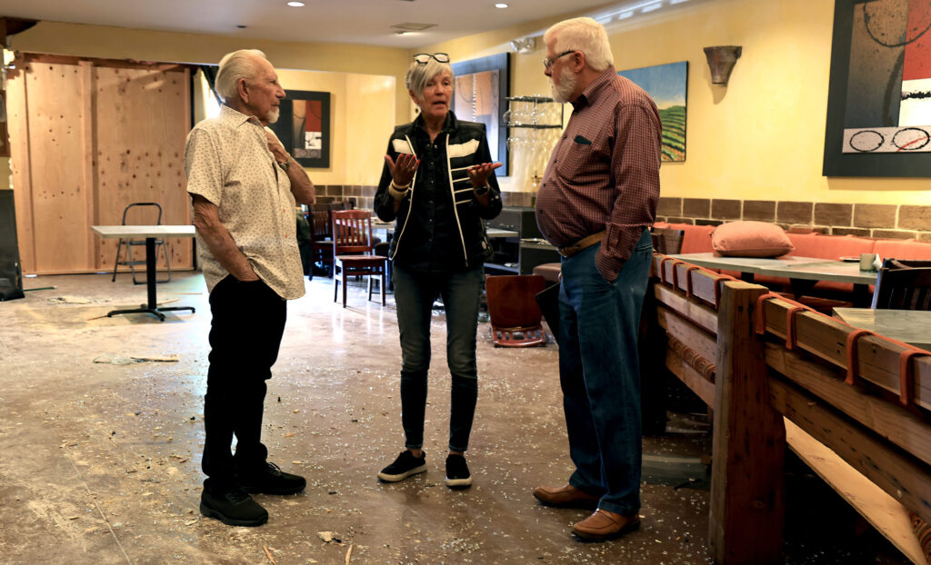 Baci Cafe and Wine Bar owner Lisbeth Holmefjord talks with architect Scott Bartley, right, and Jerry Eddinger of Eddinger Enterprises, left, Tuesday, May 26, 2026, as they discuss rebuilding options after a car plowed through the restaurant Saturday morning. (Kent Porter / The Press Democrat)