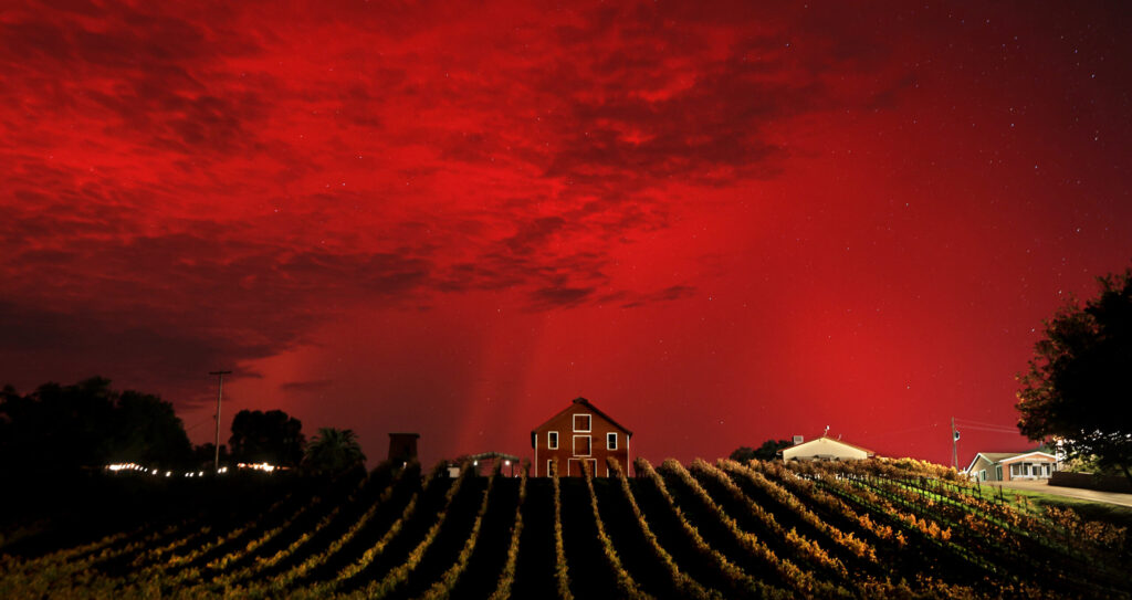 A large coronal mass ejection, or CME, hurtled through space and hit Earth square on, creating a mid-latitude aurora borealis sub-storm, Tuesday night, Nov. 11, 2025. The photo was made along Dry Creek Road viewing north at Timber Crest Farms in Healdsburg. (Kent Porter / The Press Democrat)