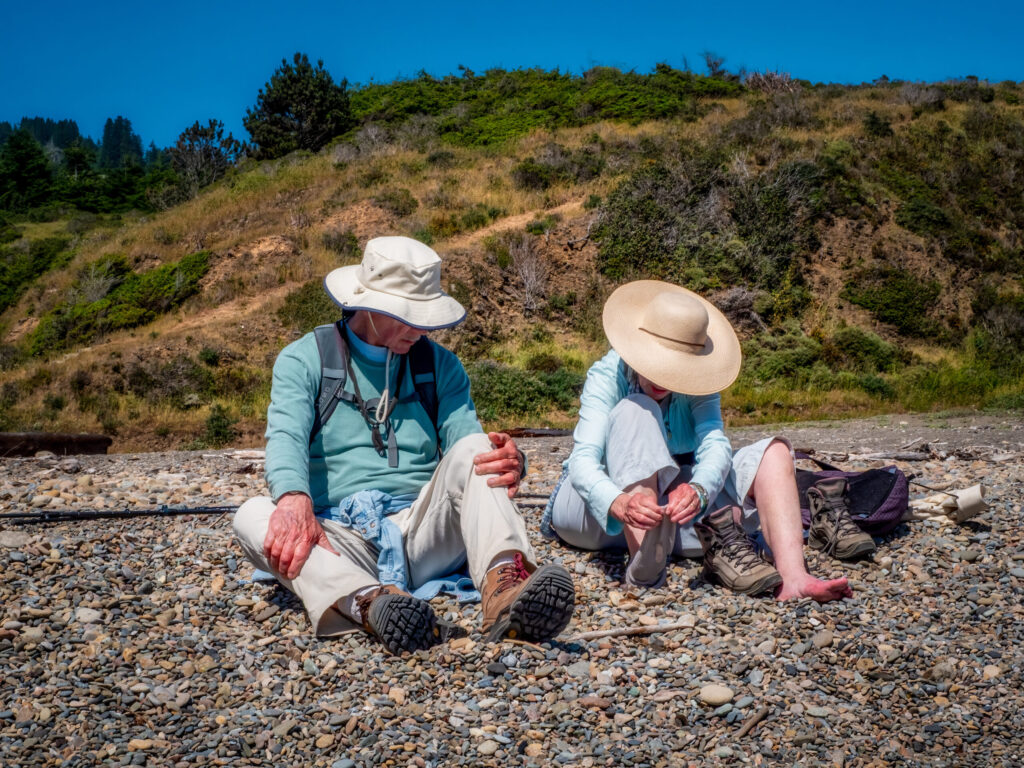 A couple rests their tired feet at the end of the Camino de Sonoma. (Sam Mills)