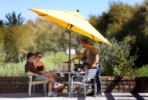 Server Antonio Trevino, right, pours wine for guests Angela Hang and Enoch Z. during a tasting at Lynmar Estate Winery in Sebastopol Sunday, Sept. 6, 2026. (Beth Schlanker / The Press Democrat)