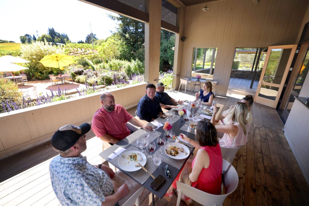 A group of friends from Kenwood eat lunch at Lynmar Estate Winery in Sebastopol Sunday, Sept. 6, 2026. (Beth Schlanker / The Press Democrat)
