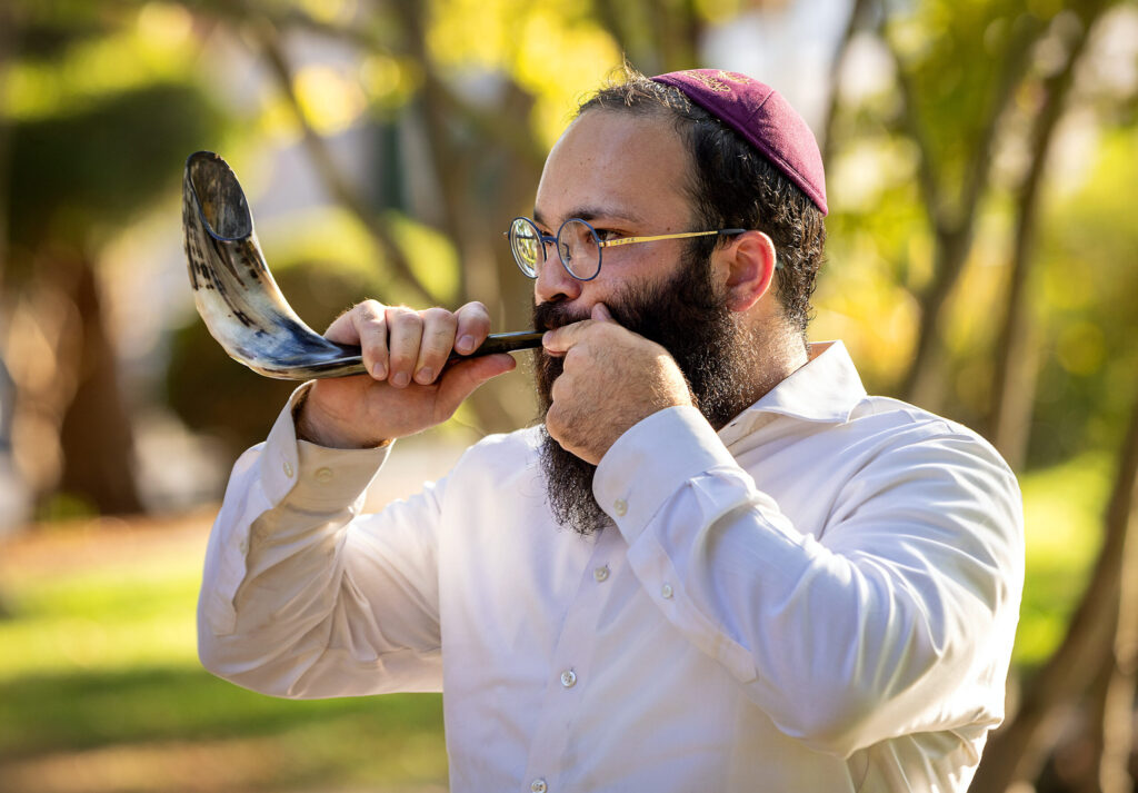 Rabbi Mendy Wegner, leader of the Chabad Jewish Center of Sonoma Valley, sounds the Shofar, a Rosh Hashanah tradition of blowing into a ram's horn to remind us to repent our sins and make things right with God and others Tuesday, Sept. 23, 2025 in the Sonoma Plaza. (John Burgess / The Press Democrat)