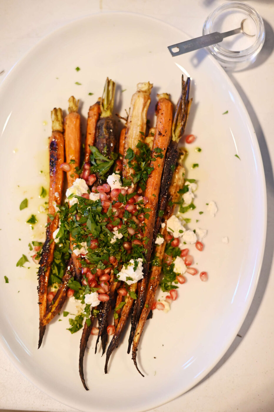 Honey roasted carrots with goat cheese and pomegranate arils during Barbara Shenson’s Rosh Hashanah recipes cooking class at a Jewish food retreat held at the Union for Reform Judaism Camp Newman in Santa Rosa on Saturday, Sept. 14, 2024. (Erik Castro / For The Press Democrat)